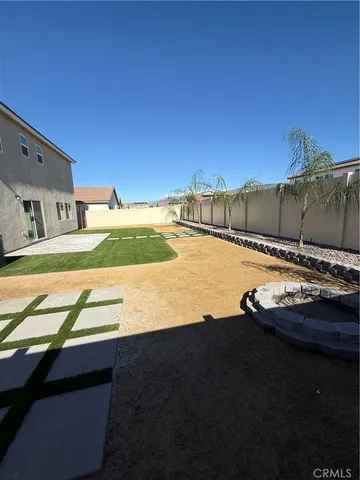 a view of a swimming pool with a yard