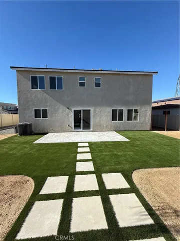 a backyard of a house with table and chairs