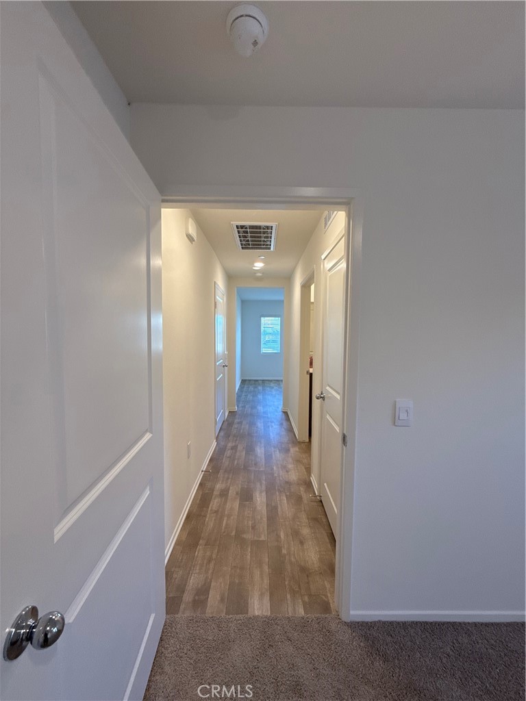 479 Hollyhock Circle San Jacinto, CA 92582 - Photo 29 of 36 a view of a hallway with wooden floor and staircase