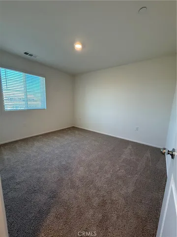 an empty room with a empty space and window