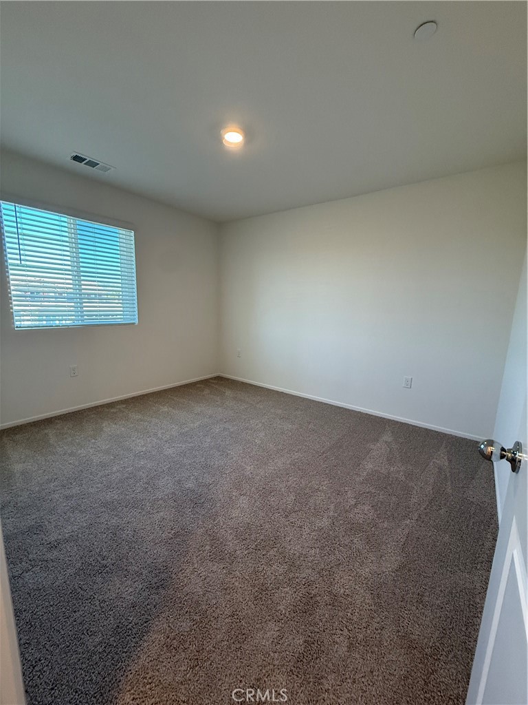 479 Hollyhock Circle San Jacinto, CA 92582 - Photo 10 of 36 an empty room with a empty space and window