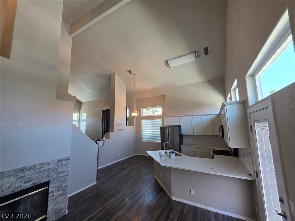 2275 Ramsgate Drive Henderson, NV 89074 - Photo 25 of 84 The open-concept design seamlessly blends the kitchen with the adjacent living area, highlighted by soaring vaulted ceilings.