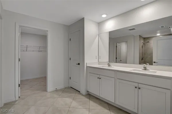 a bathroom with a double vanity sink and a mirror