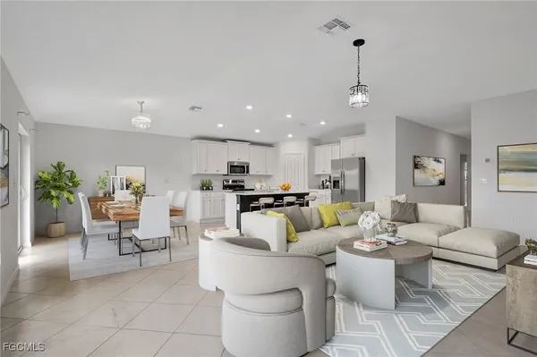 a living room with furniture and a view of kitchen