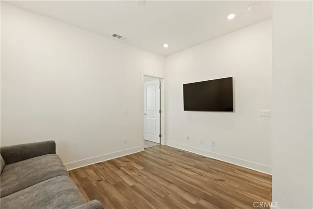 a view of livingroom with wooden floor and flat screen tv