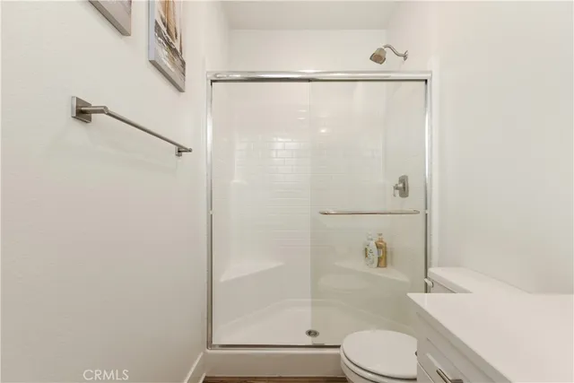 a bathroom with a shower a toilet and a shower