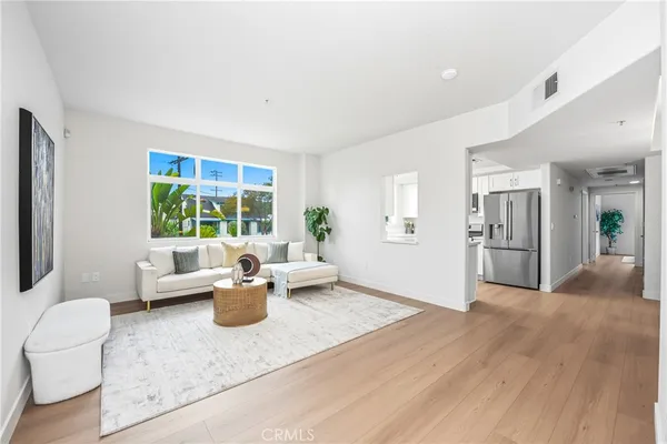 a living room with furniture and large windows