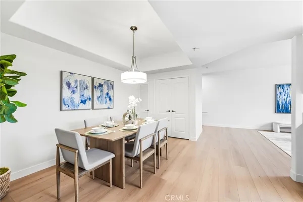 a view of a dining room with furniture wooden floor and chandelier