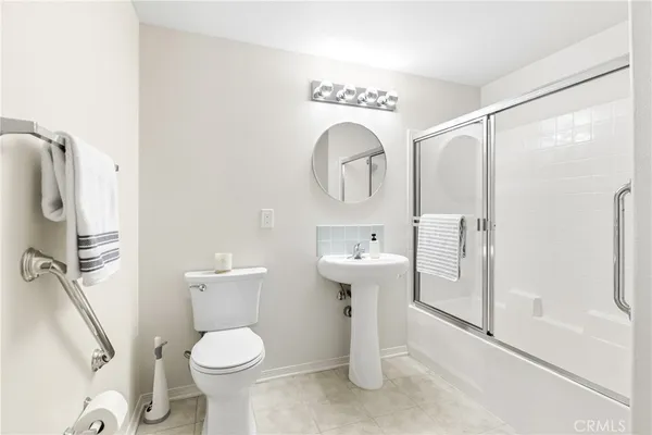a bathroom with a toilet sink and a shower