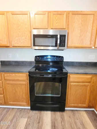 a stove top oven sitting inside of a kitchen