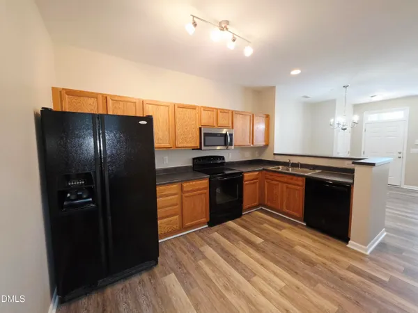 a kitchen with granite countertop stainless steel appliances and refrigerator