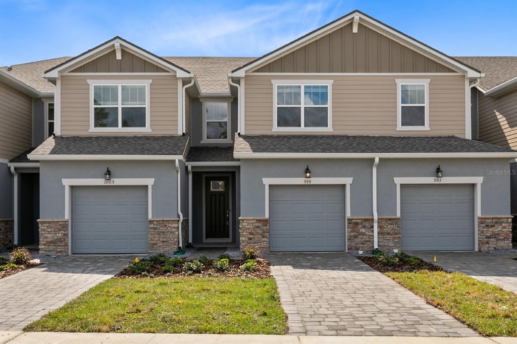 999 Spring Palms Loop Orlando, FL 32828 - Photo 1 of 1 a front view of a house with a yard and garage