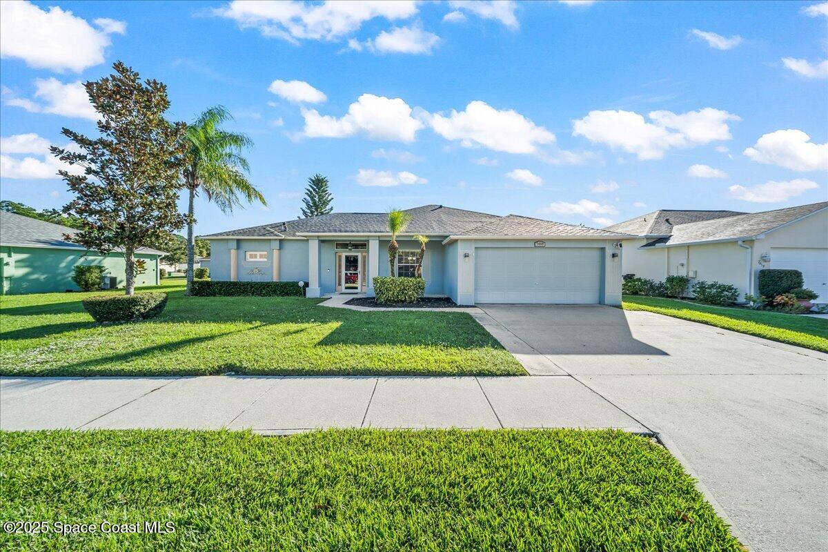 7469 Hackberry Road Cocoa, FL 32927 - Photo 1 of 27 a front view of a house with a yard and potted plants