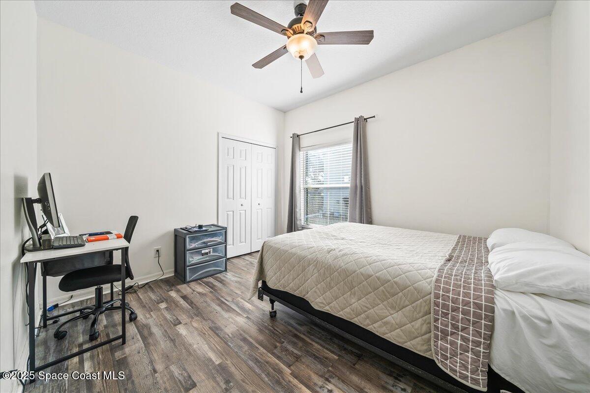 7469 Hackberry Road Cocoa, FL 32927 - Photo 18 of 27 a bedroom with a bed and a desk
