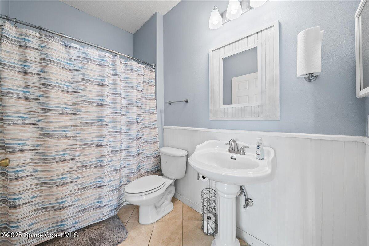 7469 Hackberry Road Cocoa, FL 32927 - Photo 19 of 27 a bathroom with a sink a toilet and mirror