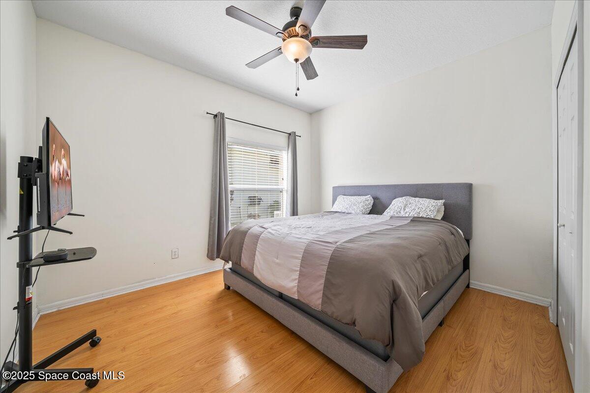 7469 Hackberry Road Cocoa, FL 32927 - Photo 20 of 27 a bedroom with a bed and a chandelier