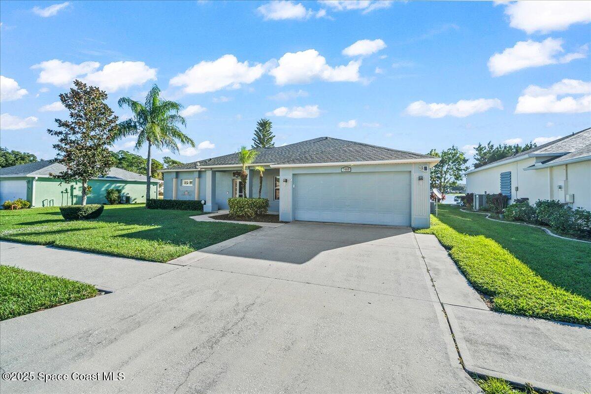 7469 Hackberry Road Cocoa, FL 32927 - Photo 2 of 27 a front view of a house with a yard and potted plants
