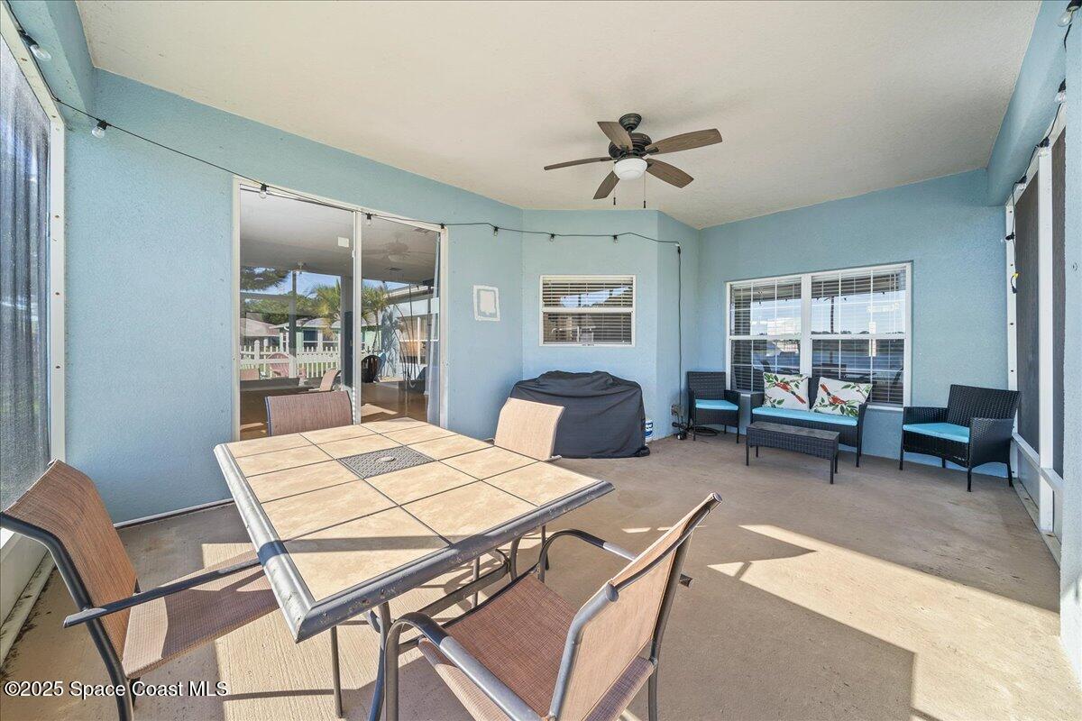 7469 Hackberry Road Cocoa, FL 32927 - Photo 23 of 27 a living room with furniture a window and a table