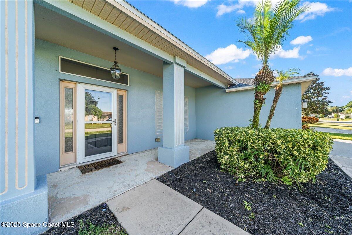 7469 Hackberry Road Cocoa, FL 32927 - Photo 3 of 27 a front view of a house with garden