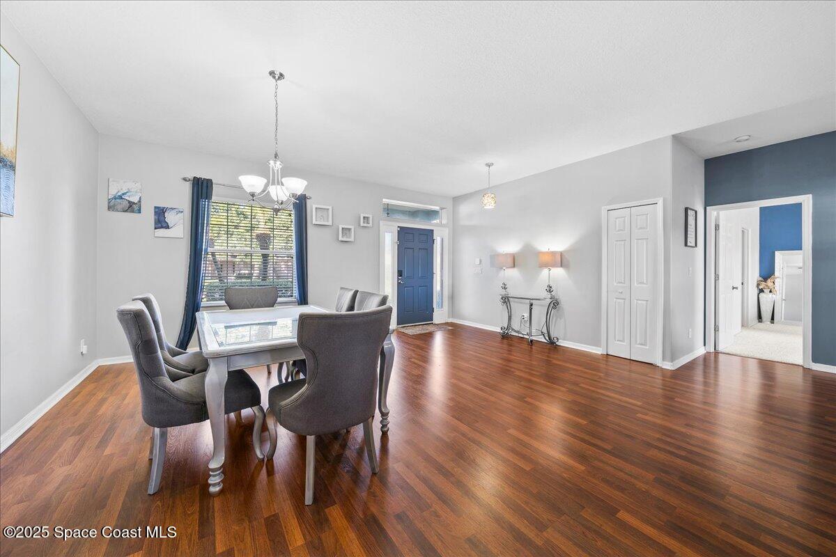 7469 Hackberry Road Cocoa, FL 32927 - Photo 4 of 27 a view of a dining room with furniture window and wooden floor