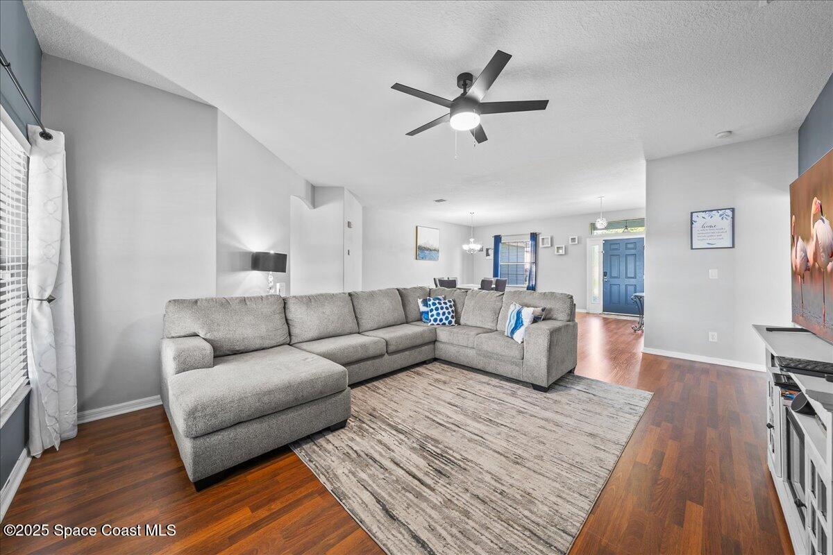 7469 Hackberry Road Cocoa, FL 32927 - Photo 7 of 27 a living room with furniture and a wooden floor