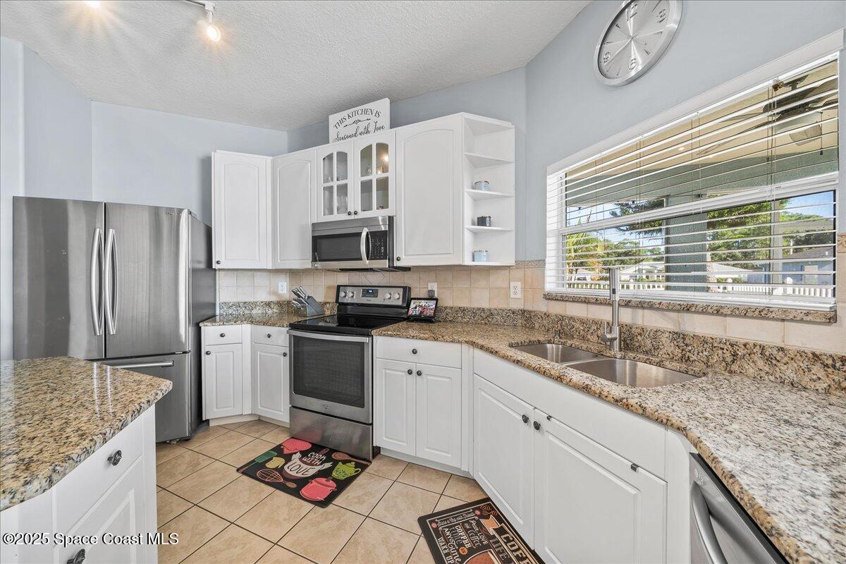 7469 Hackberry Road Cocoa, FL 32927 - Photo 10 of 27 a kitchen with a sink stove and refrigerator