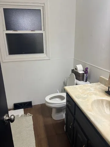 a room with a wooden floor and washing machine