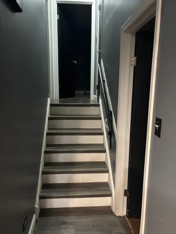 a room with wooden floor and furniture