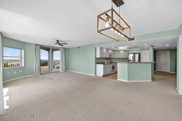 a kitchen with kitchen island a sink and refrigerator