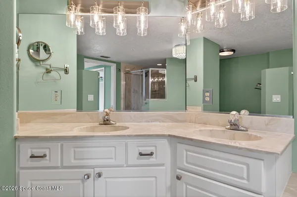 a bathroom with a granite countertop sink vanity and a mirror