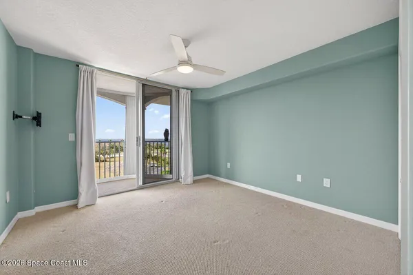 a bathroom with a bathtub and a flat screen tv