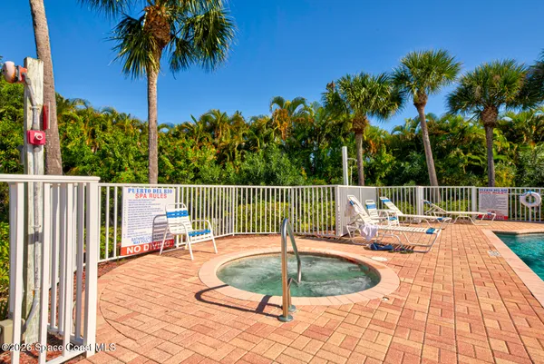 a view of swimming pool with outdoor seating and city view