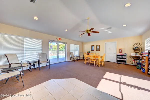 a sign that is on a brick wall with plants in front of house