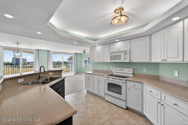a kitchen with granite countertop a sink stainless steel appliances and cabinets