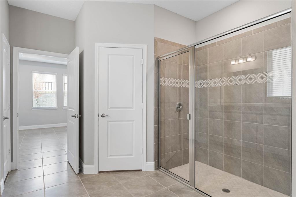 851 Vineyard Rdg Road Minneola, FL 34715 - Photo 12 of 13 a bathroom with a glass shower door