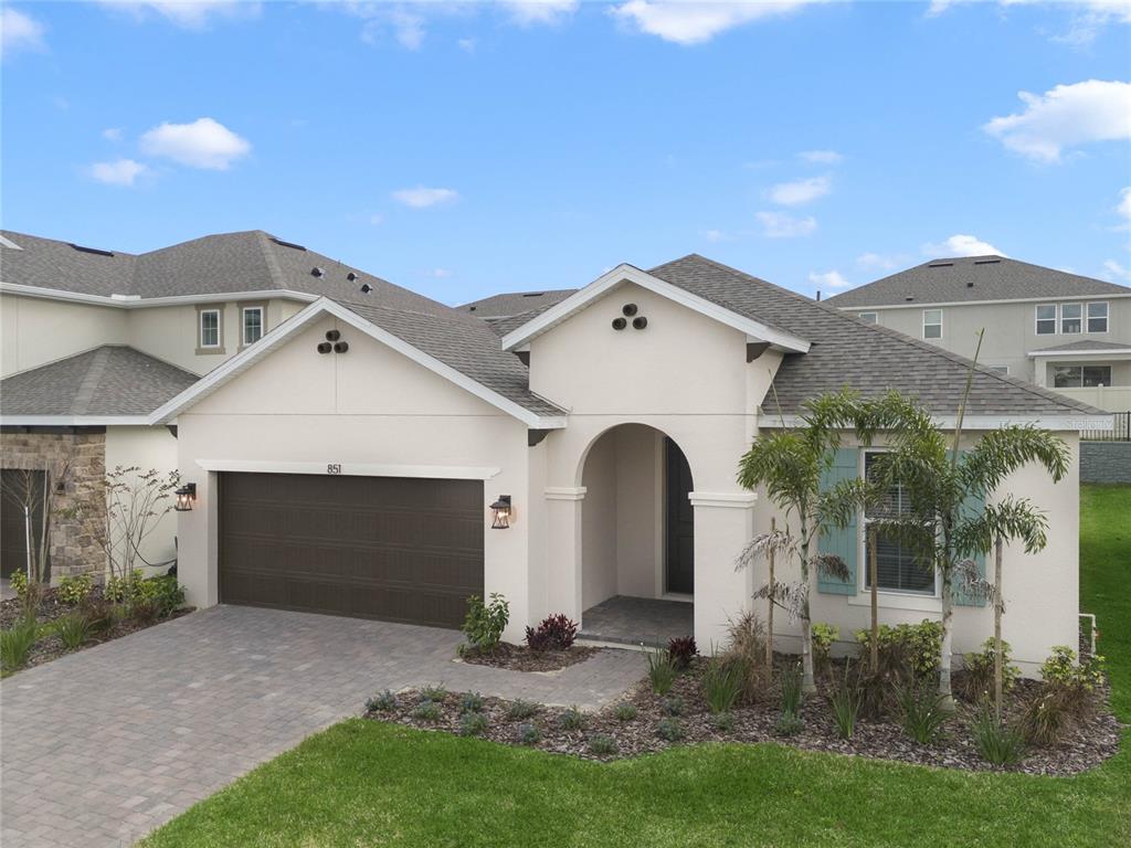 851 Vineyard Rdg Road Minneola, FL 34715 - Photo 2 of 13 a front view of a house with a yard and garage