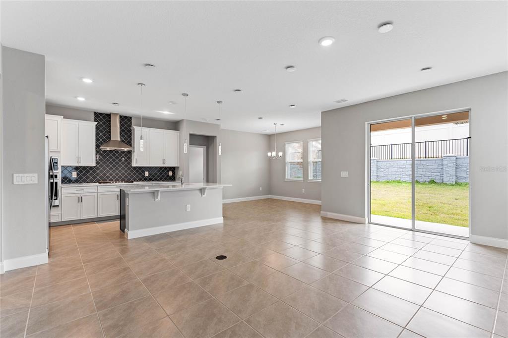 851 Vineyard Rdg Road Minneola, FL 34715 - Photo 3 of 13 a large kitchen with stainless steel appliances a large counter top a stove and a refrigerator