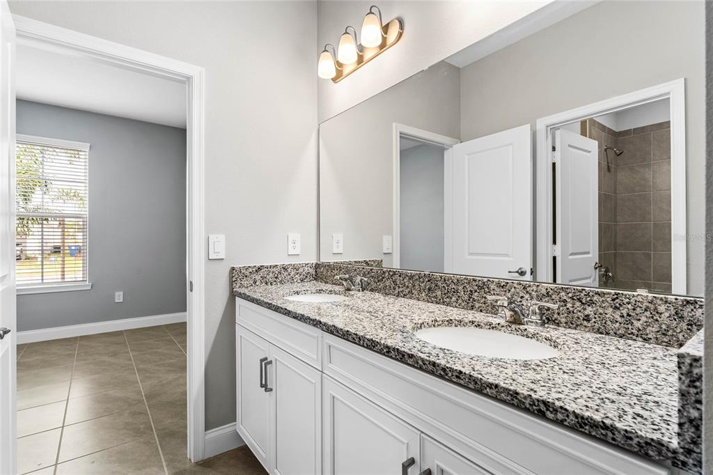 851 Vineyard Rdg Road Minneola, FL 34715 - Photo 8 of 13 a bathroom with a granite countertop sink and a mirror