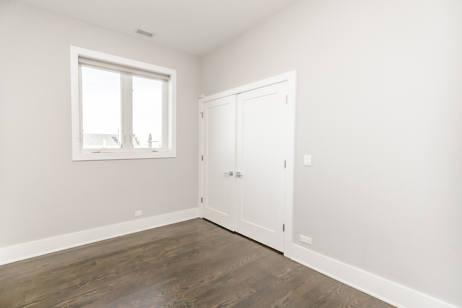 2018 South Loomis Street, Unit 3 Chicago, IL 60608 - Photo 10 of 22 an empty room with wooden floor and windows