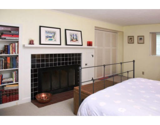 73 Elmwood Road Wellesley, MA 02481 - Photo 7 of 10 a bedroom with a bed a book shelf and a window