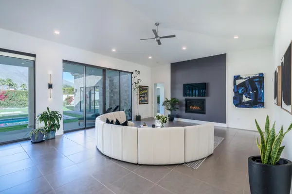 a living room with furniture and a potted plant