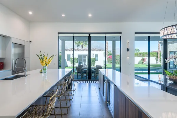 a dining room with furniture a chandelier and wooden floor