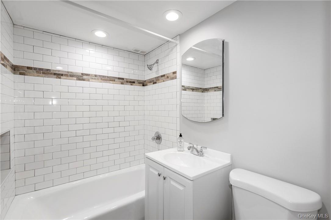 150 Overlook Avenue, Unit 2K Peekskill, NY 10566 - Photo 7 of 26 a bathroom with a bathtub shower sink vanity and toilet