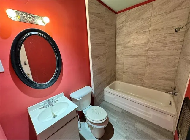 a bathroom with a toilet a sink and bathtub