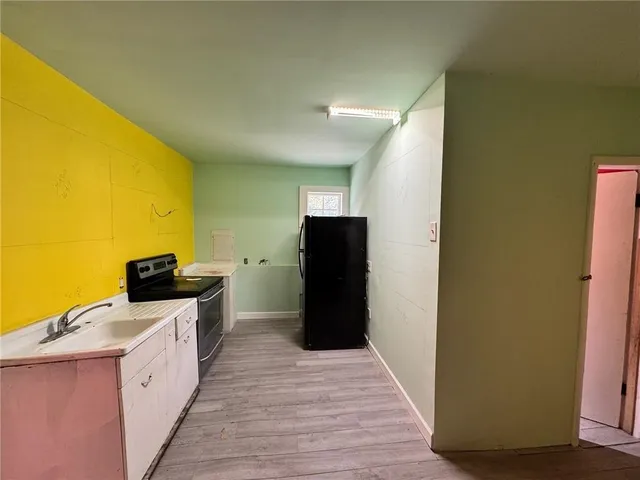 a kitchen with stainless steel appliances a refrigerator and a stove