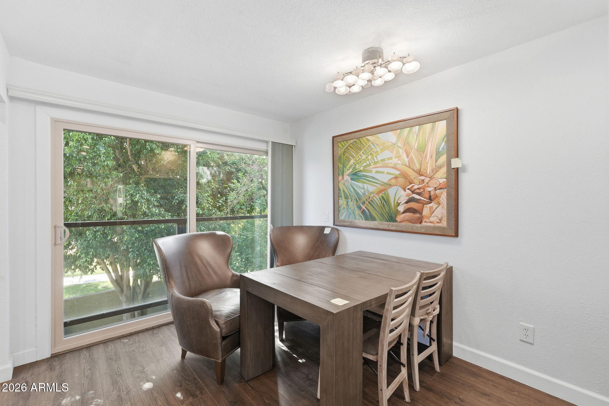 4201 East Camelback Road, Unit 34 Phoenix, AZ 85018 - Photo 6 of 19 a view of a dining room with furniture window and wooden floor