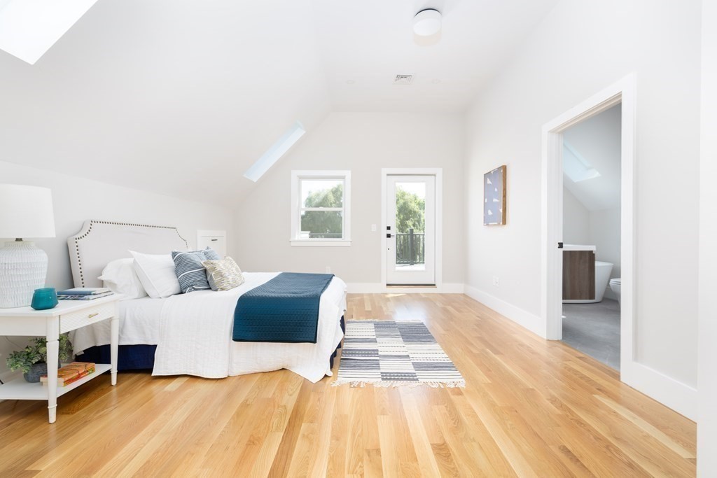 10 Hardan Road, Unit 10 Somerville, MA 02144 - Photo 13 of 22 a bedroom with a bed and a view of bathroom