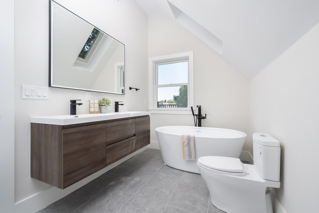 10 Hardan Road, Unit 10 Somerville, MA 02144 - Photo 15 of 22 a bathroom with a toilet sink and mirror