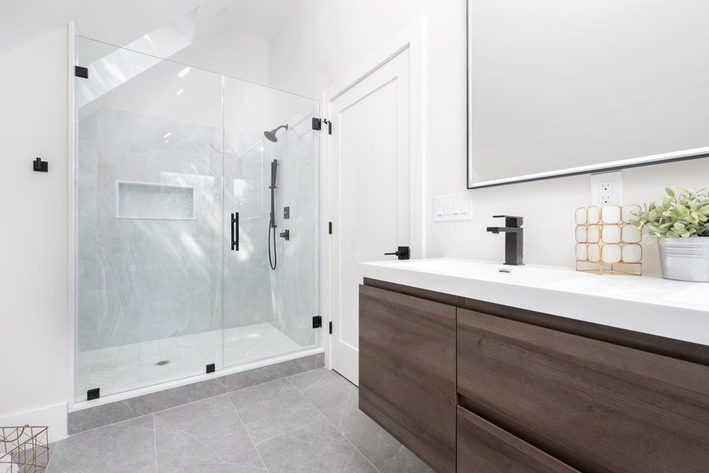 10 Hardan Road, Unit 10 Somerville, MA 02144 - Photo 16 of 22 a bathroom with a shower sink and mirror