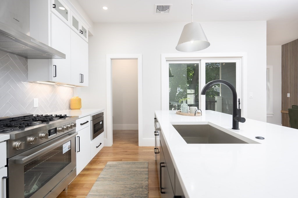 10 Hardan Road, Unit 10 Somerville, MA 02144 - Photo 7 of 22 a kitchen with a stove a sink and a refrigerator